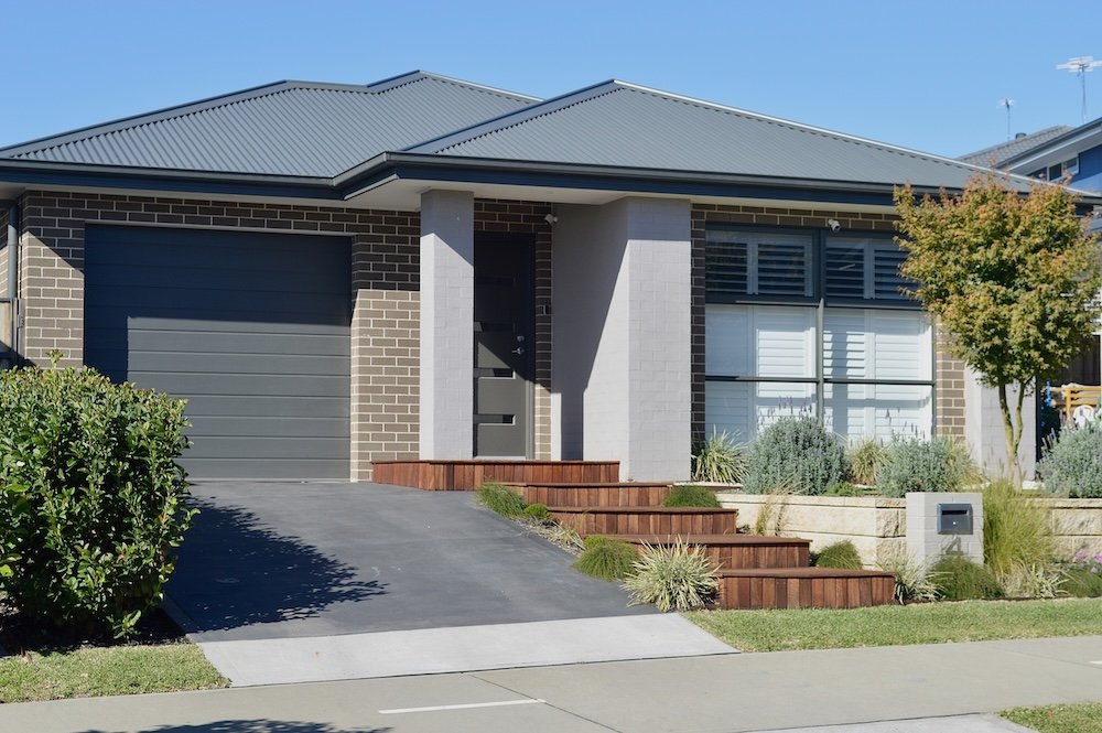 A view of a house in the suburbs n a sunny afternoon
